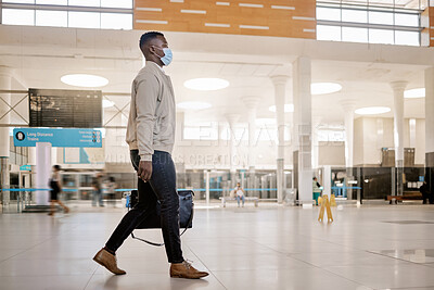 Buy stock photo Walking, travel and businessman with mask in lobby for transport, journey and trip for commute for work. Worker, professional and person with bag in airport, train station or terminal with protection