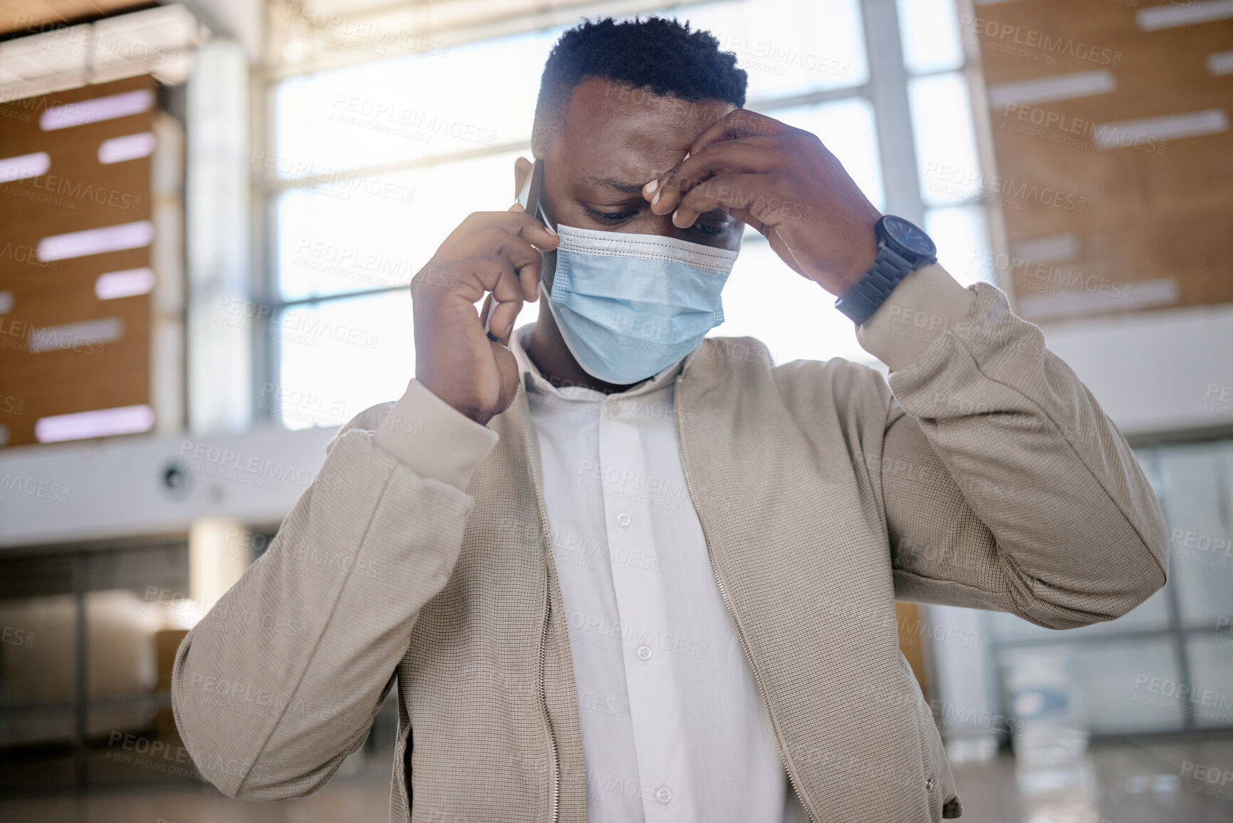 Buy stock photo Man, mask and phone call at train station for travel, conversation or terminal with stress for delay. African person, listen and ppe with headache, smartphone or mistake for schedule on business trip