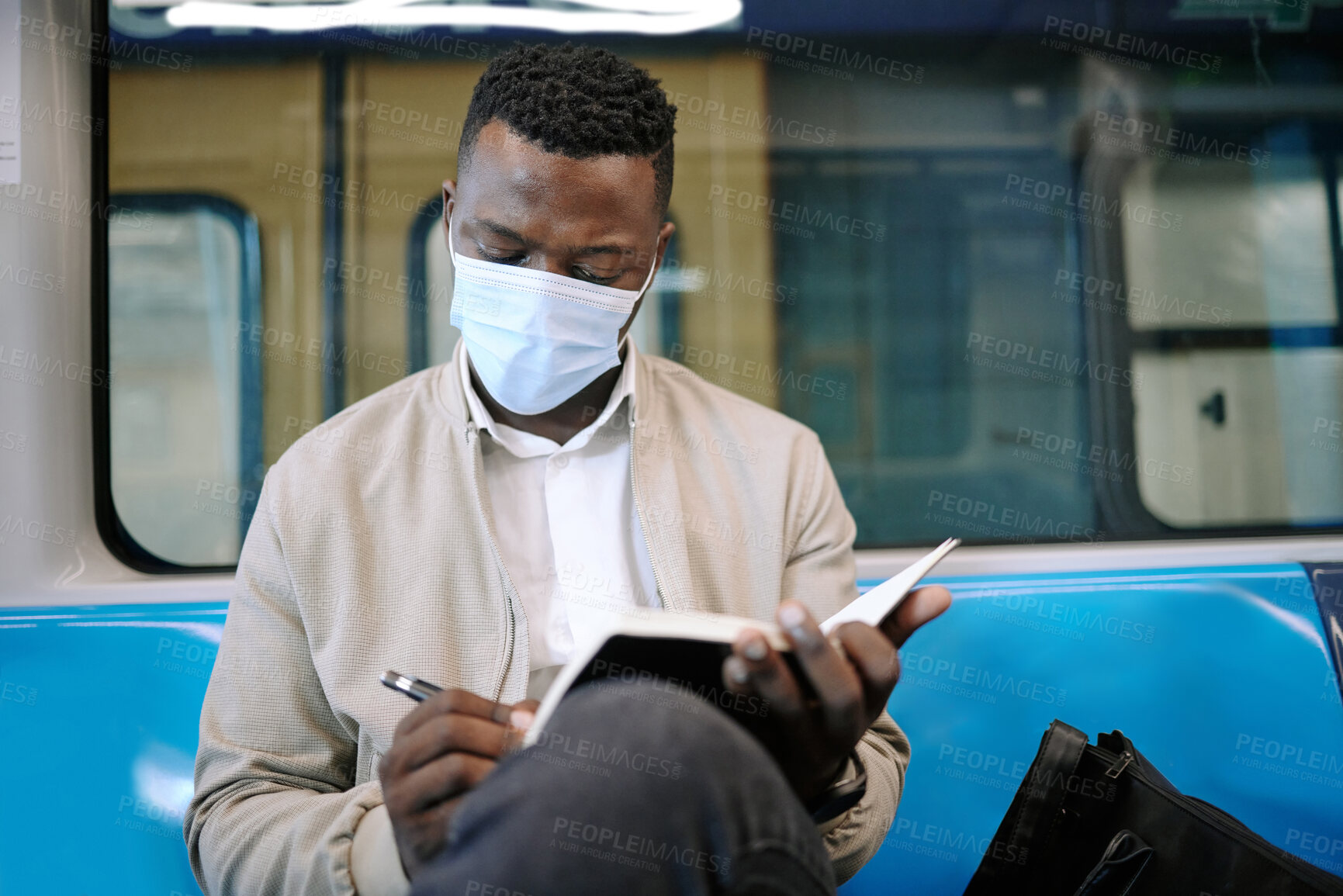 Buy stock photo Travel, writing and businessman on train with mask for public transport, journey and trip to work. Passenger, professional and person with notebook on subway, metro railway and commute in town