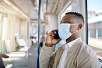 Black businessman travelling alone. A young african american businessman using a cellphone while sitting at the window on a train during his commute to the city