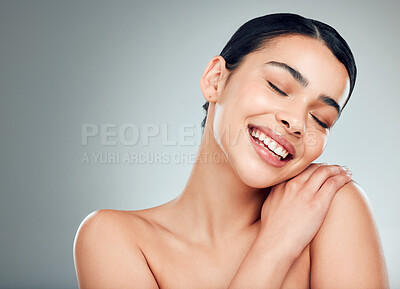 Buy stock photo Skincare, cosmetics and woman with smile, shine and dermatology on gray studio background. Person, girl and model with happiness, grooming routine and treatment for smooth skin, glow and aesthetic