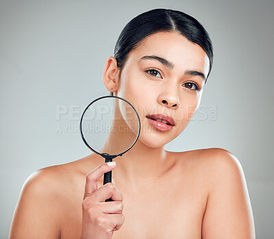 Buy stock photo Woman, portrait and magnifying glass for skincare, acne and facial treatment with results or inspection. Model, face and skin investigation in studio on white background for beauty, search or texture