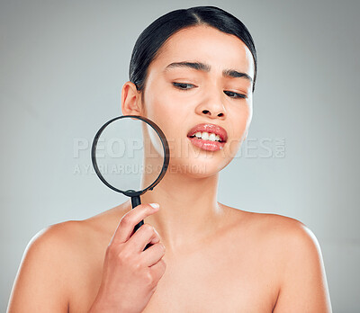 Buy stock photo Woman, check and magnifying glass for skincare, skin and facial treatment with results or inspection. Model, face and acne investigation in studio on white background for beauty, search or texture