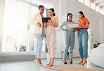 Group of businesswomen talking and using a digital tablet and report together at work. Serious businesspeople talking and planning while standing in an office