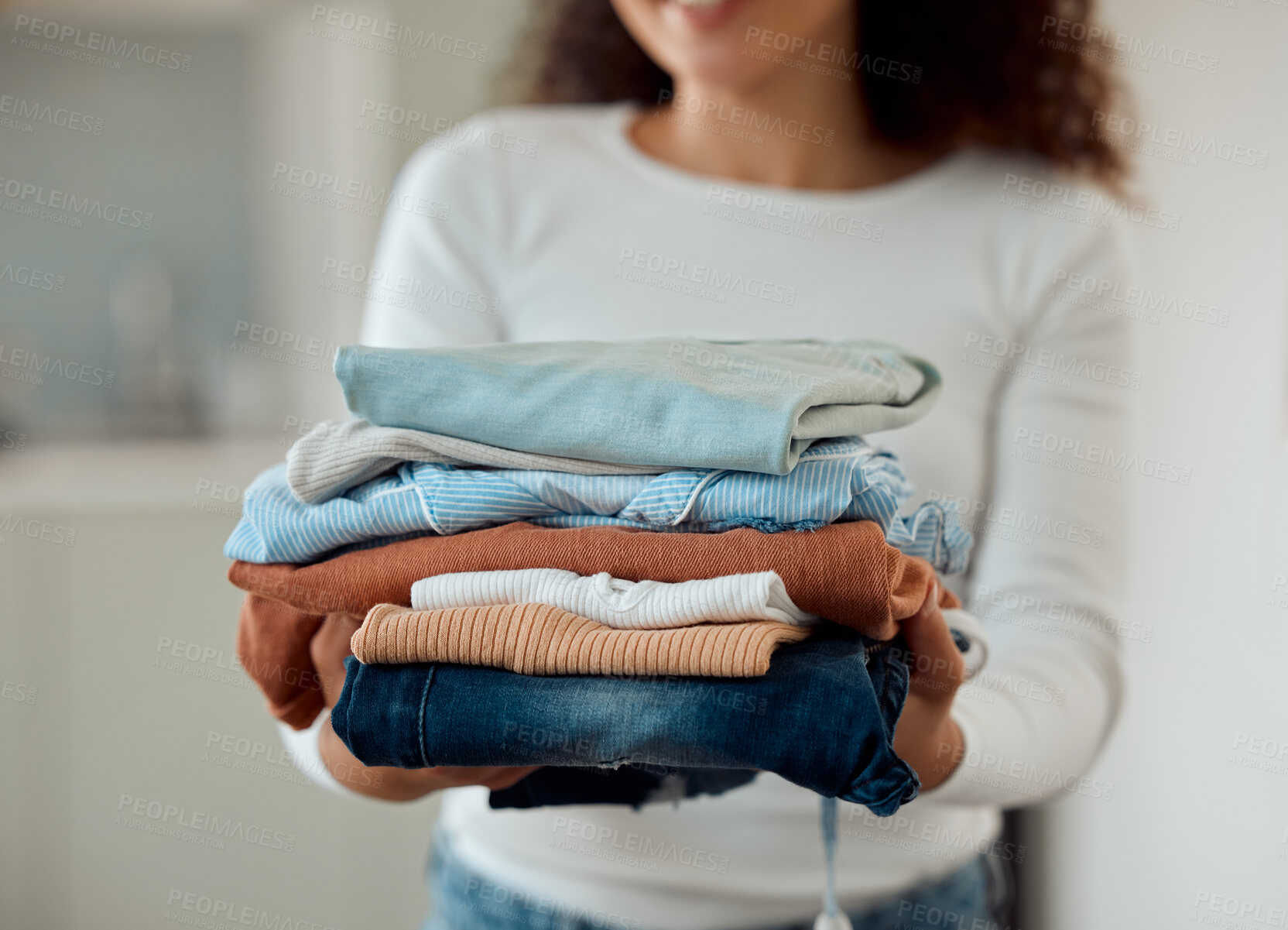 Buy stock photo Laundry, hands and woman in home with washing, housework and weekend chores in living room. House work, clothes and girl in apartment with cleaning, packing and folding fresh linen for household care