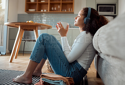 Buy stock photo Woman, headphones and home with music, coffee and morning on floor with rest in living room. Audio, calm and hot drink with team, podcast streaming and internet song on a relax weekend in break