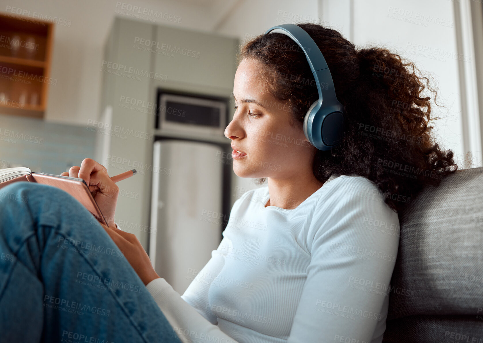 Buy stock photo Woman, headphones and home for writing in book, podcast inspiration and gratitude journal. Female person, planner and streaming radio or audio on floor of apartment, ideas and notepad for self care