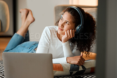 Buy stock photo Woman, headphones and home with thinking, laptop and morning on floor with smile in living room. Audio, streaming and internet podcast with online and relax with technology and student day dreaming