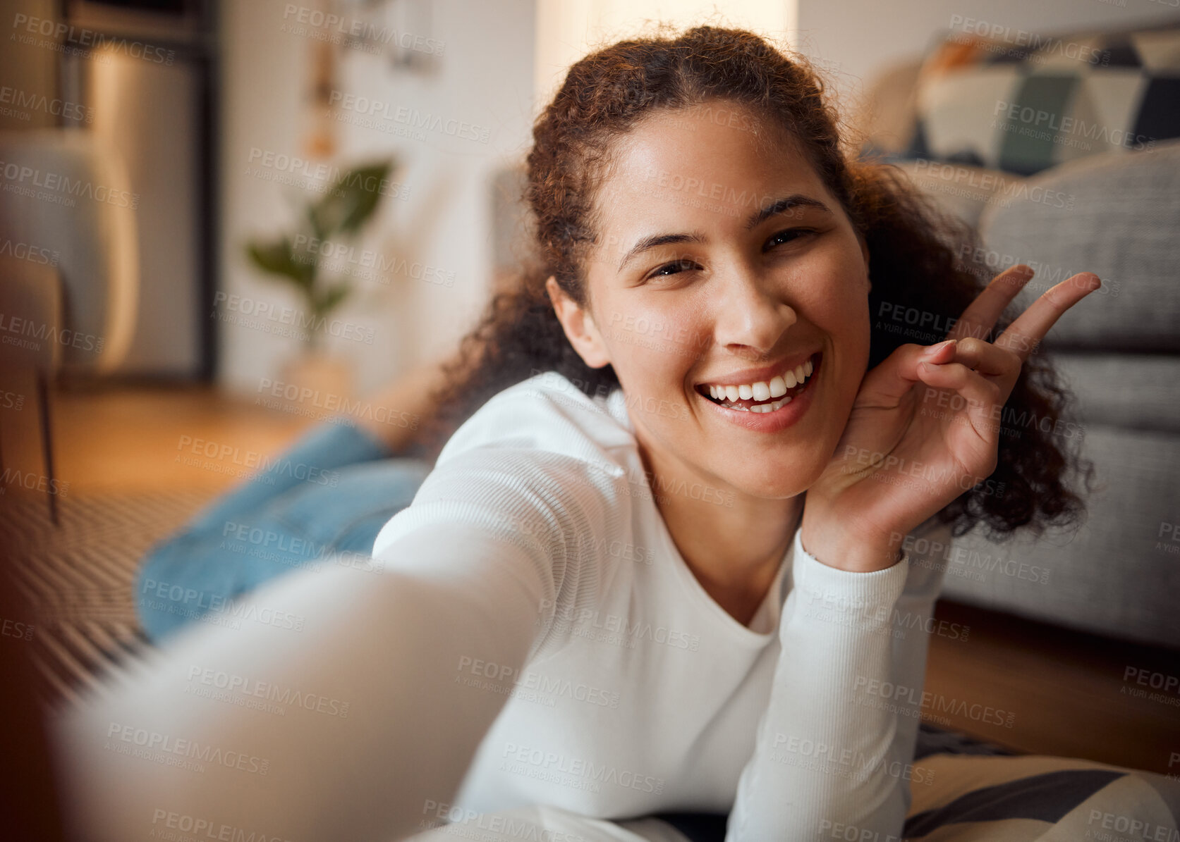 Buy stock photo Woman, selfie and home portrait with peace sign, social media update and relax on floor for post. Female person, emoji and online for photography in living room, picture and symbol for kindness