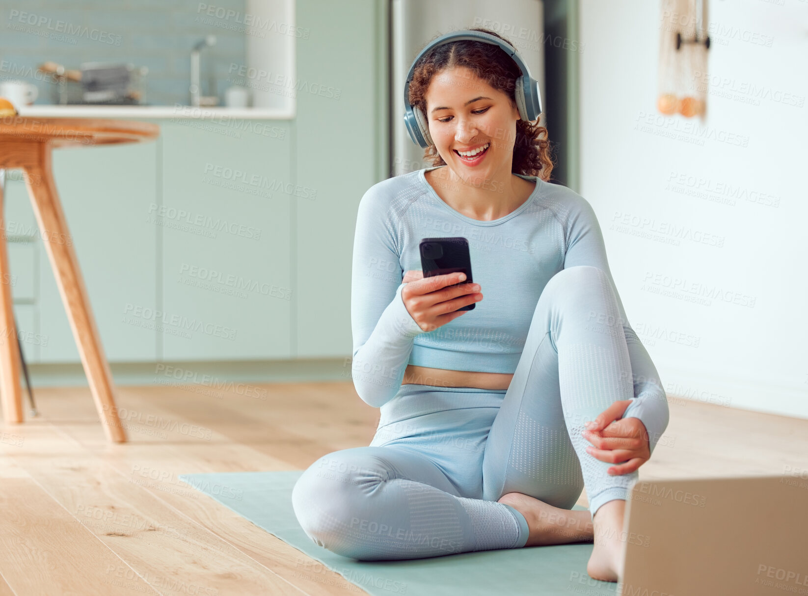 Buy stock photo Woman, phone and headphones with yoga mat and online fitness routine with tutorial in home. Workout, exercise and internet with wellness, mobile and website scroll in living room with texting