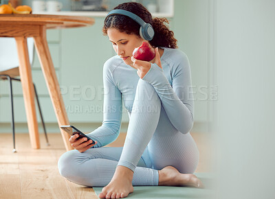 Buy stock photo Woman, phone and headphones with apple and yoga mat and online fitness routine with tutorial in home. Workout, exercise and internet with wellness, mobile and website in living room with health