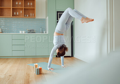 Buy stock photo Woman, yoga and handstand in home with balance, strong and muscle for wellness with candles for peace. Girl, person and adho mukha vrksasana with exercise mat for pilates, process and health in house