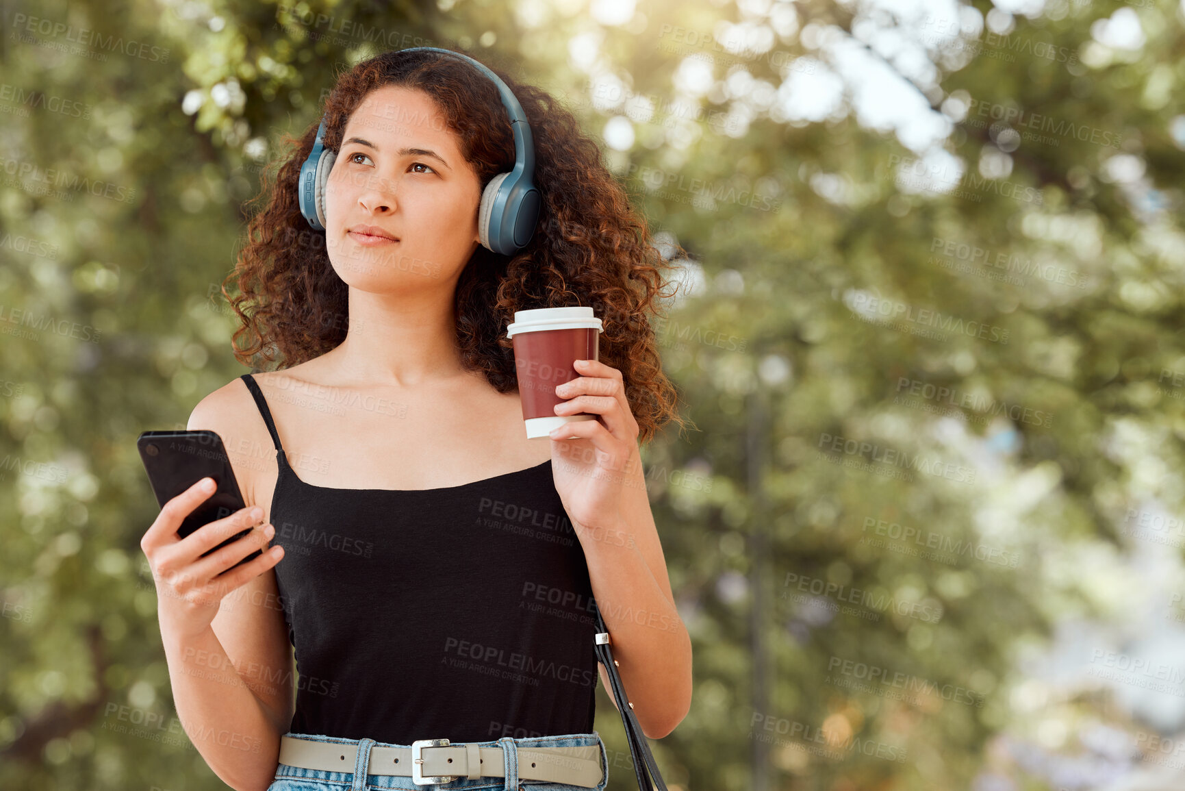 Buy stock photo Thinking, headphones and woman with coffee, phone and online podcast on outdoor walk for travel. Ideas, music streaming and gen z girl with drink, mobile app and connection on morning commute in park