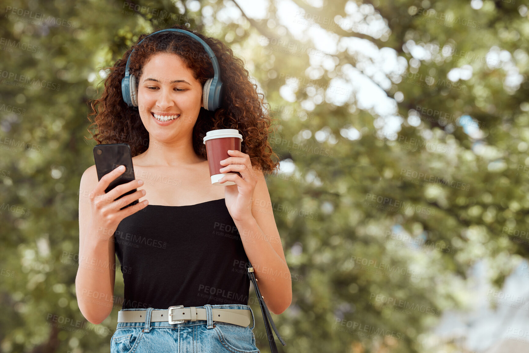 Buy stock photo Park, headphones and happy woman with coffee, phone and online podcast on outdoor walk for travel. Ideas, music streaming and gen z girl with drink, smile and mobile app connection on morning commute