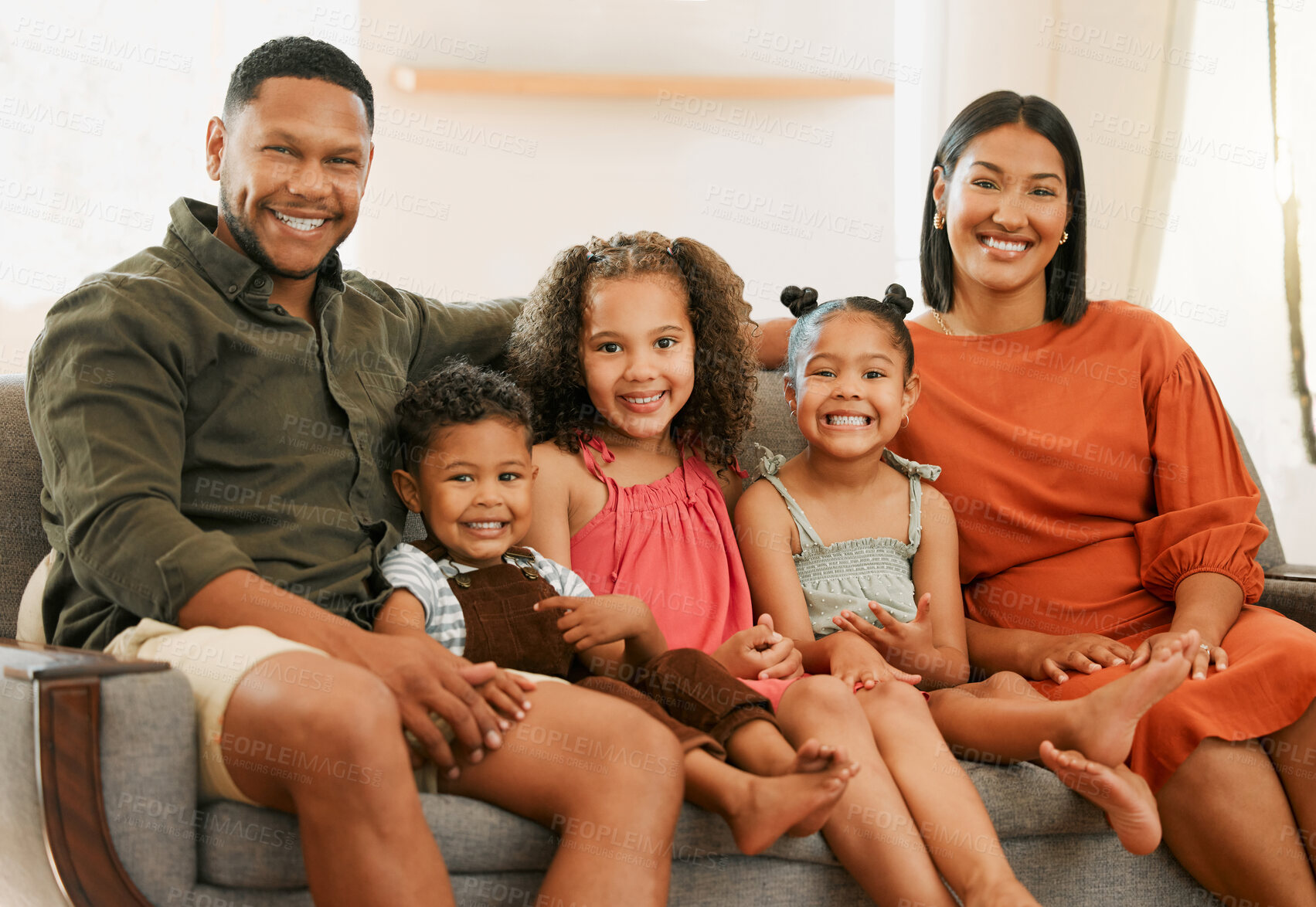 Buy stock photo Smile, portrait and bonding with family on sofa in lounge for love, morning and happiness together. Care, relax  and break with parents and children in living room at home for hug, calm and peace