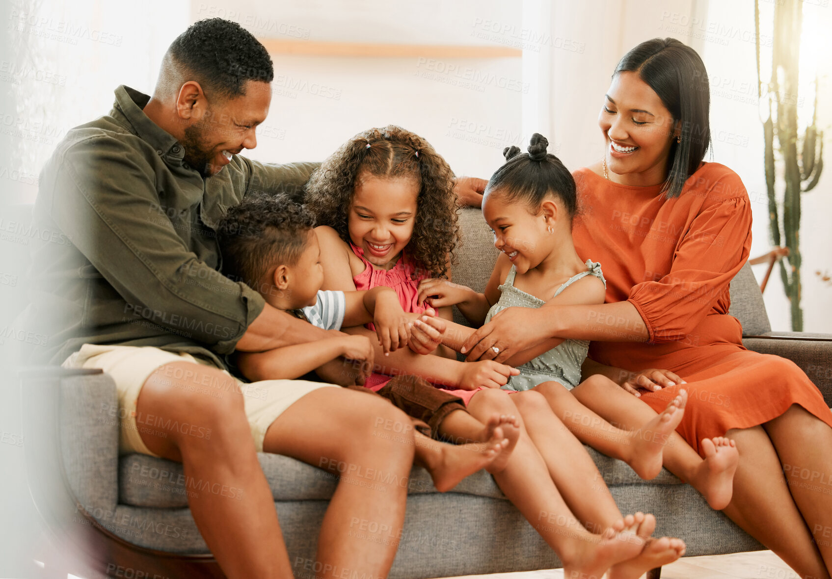 Buy stock photo Funny, tickle and laughing with family on sofa for love, playful game and happiness together. Care, energy and bonding with parents and children in living room at home for silly, comedy and joke