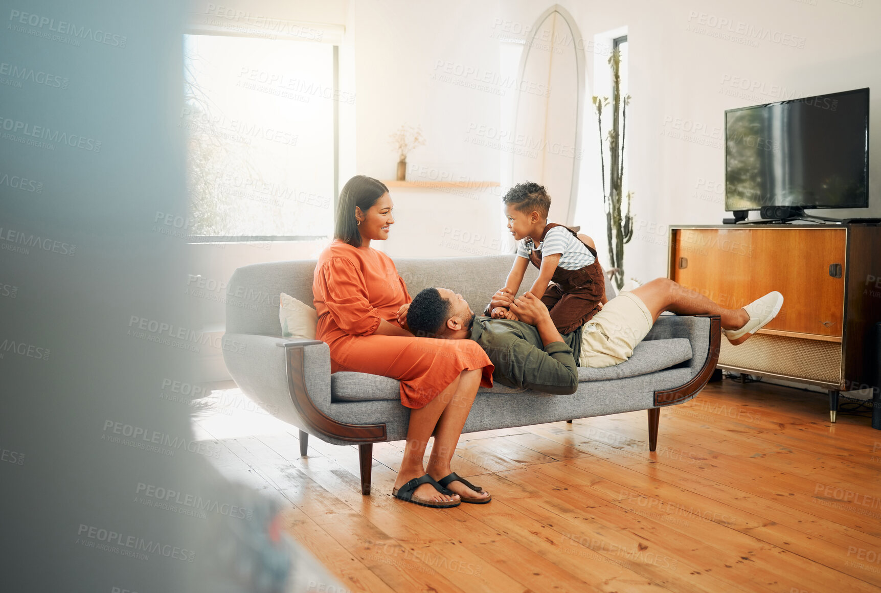 Buy stock photo Home, family and fun in living room with play, mother and African kid together with bonding on sofa. Happy, weekend and father with love, support and care with youth and morning in lounge with joy