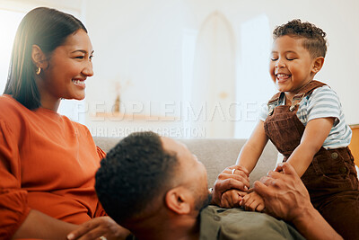 Buy stock photo Funny, smile and relax with family on sofa for love, playful game and happiness together. Care, bonding and laughing with parents and child in living room at home for silly, comedy and support