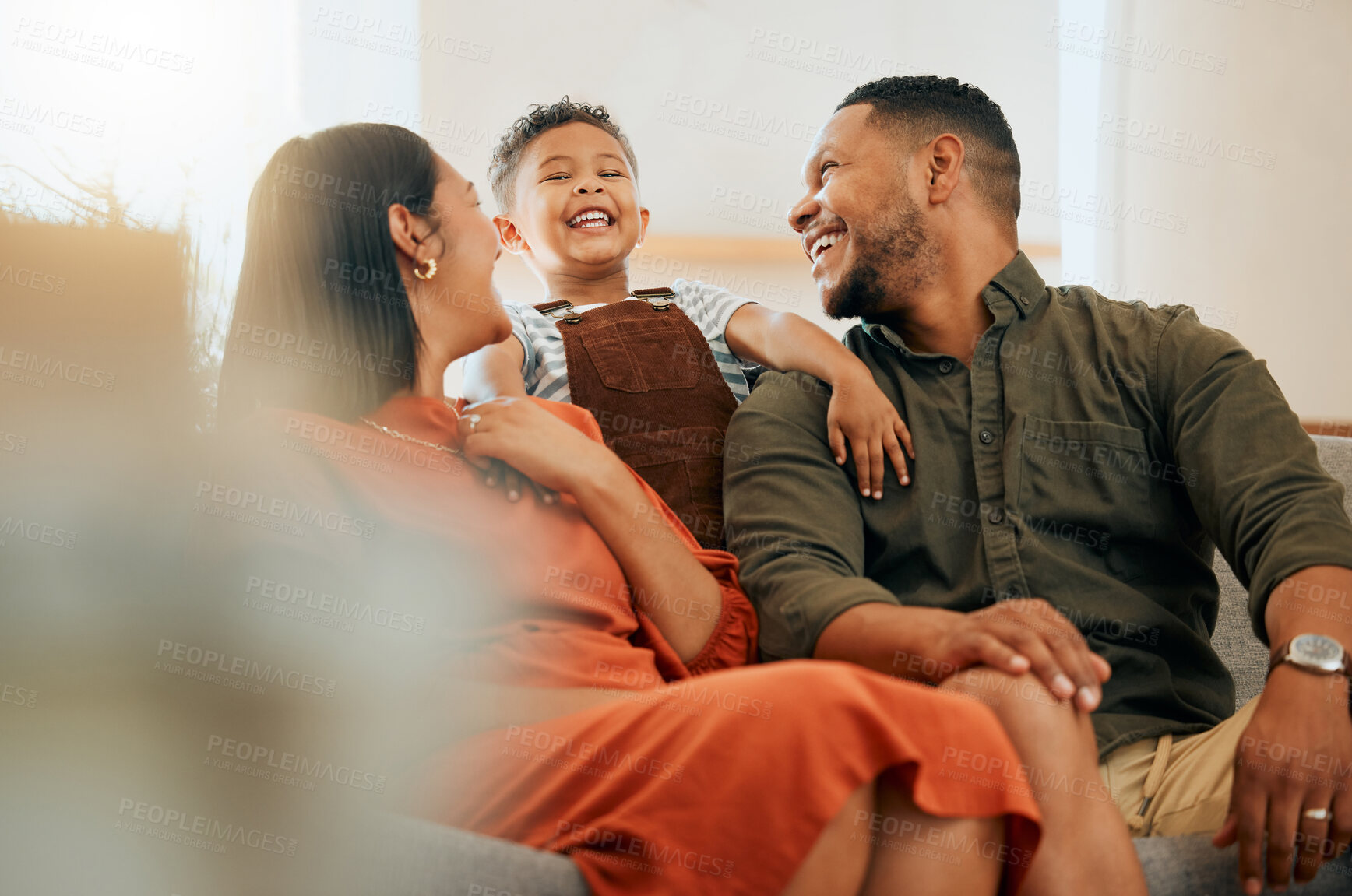 Buy stock photo Laughing, smile and relax with family on sofa for love, comfortable and happiness together. Care, bonding and break with parents and child in living room at home for silly, morning and support