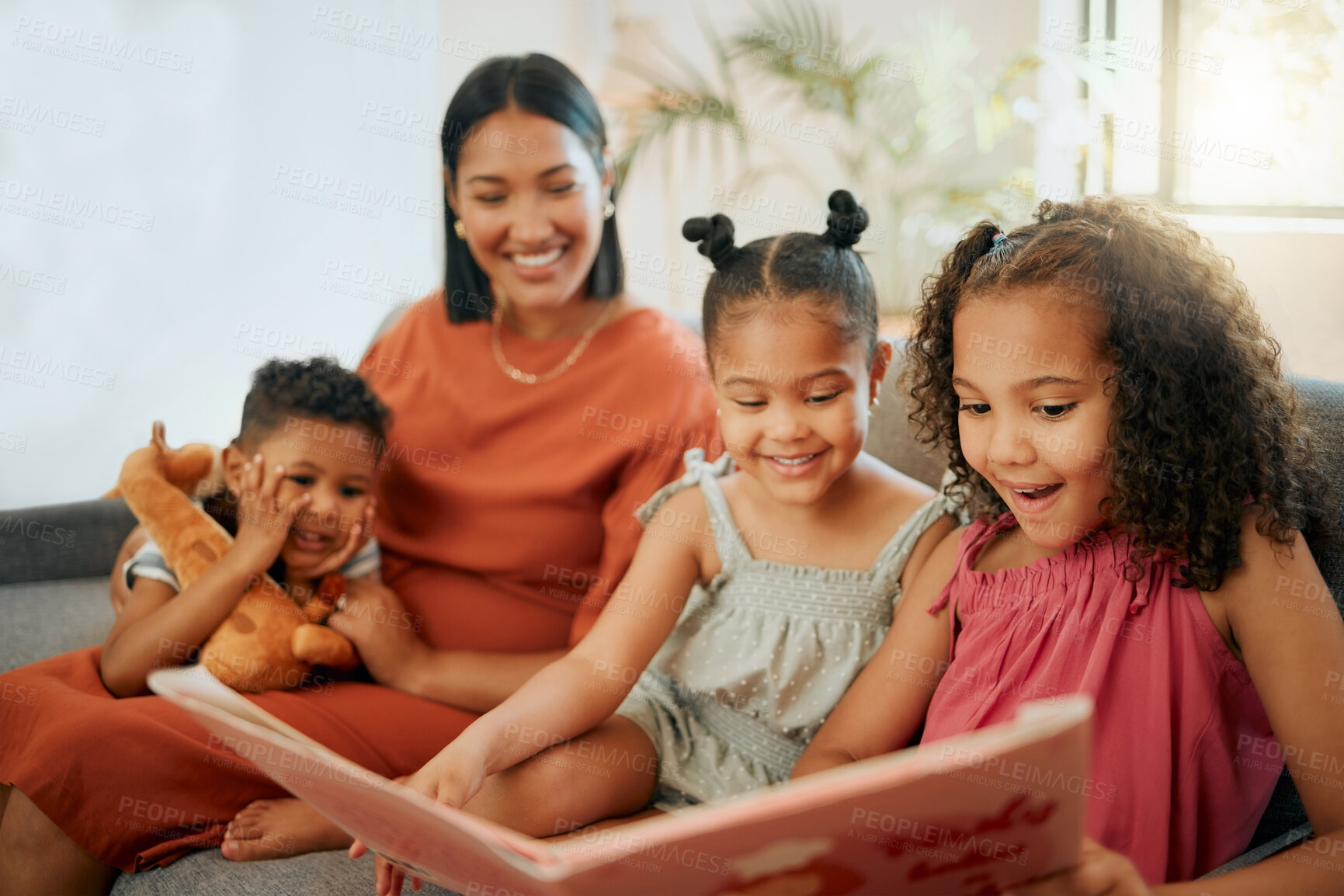 Buy stock photo Home, family and story book in living room with reading, mother and African kids with bonding on sofa. Happy, weekend and development with love, support and care with youth learning in lounge