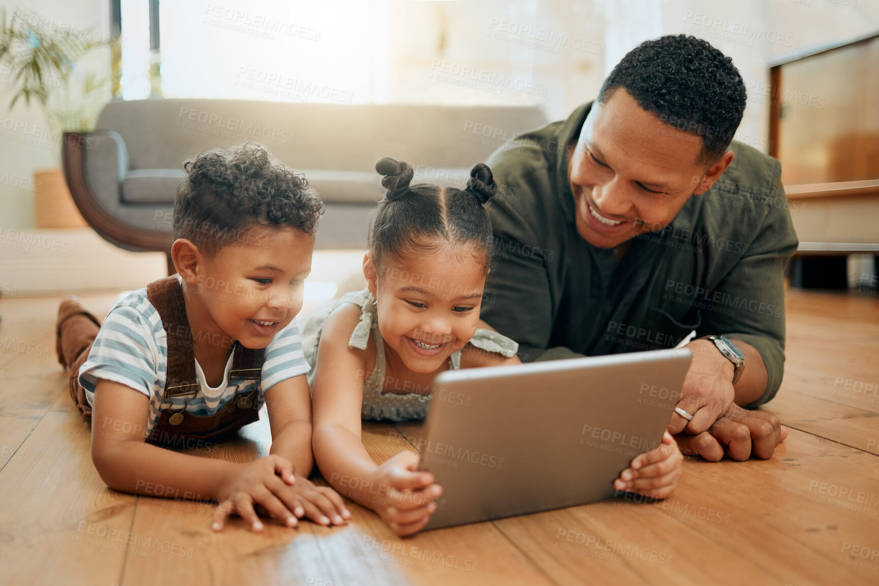 Buy stock photo Dad, children and tablet on floor in home for playing games, watching online cartoons and bonding together. Man, happy kids and digital tech in lounge with movie entertainment on streaming service