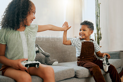 Buy stock photo High five, controllers and children on sofa with video game for bonding, weekend and relax in home. Happy, rest and kid siblings streaming electronic entertainment for fun in living room at house.