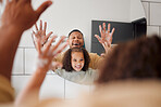 Happy mixed race father and daughter washing their hands  together in a bathroom at home. Single African American parent teaching his daughter about hygiene while having fun and being playful