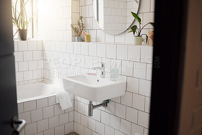 Buy stock photo Bathroom, interior and empty in home with basin, bath and sunshine with mirror for cleaning routine. Room, bathtub and sink for hygiene, wellness and washing for bacteria, plants and morning in house