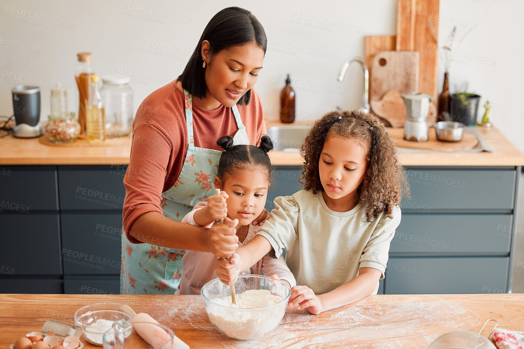 Buy stock photo Kitchen, woman and mixing in bowl with children at home for support, help and learning baking recipe. Family, mother and kids with spoon on table for ingredients, preparation and teaching to cook