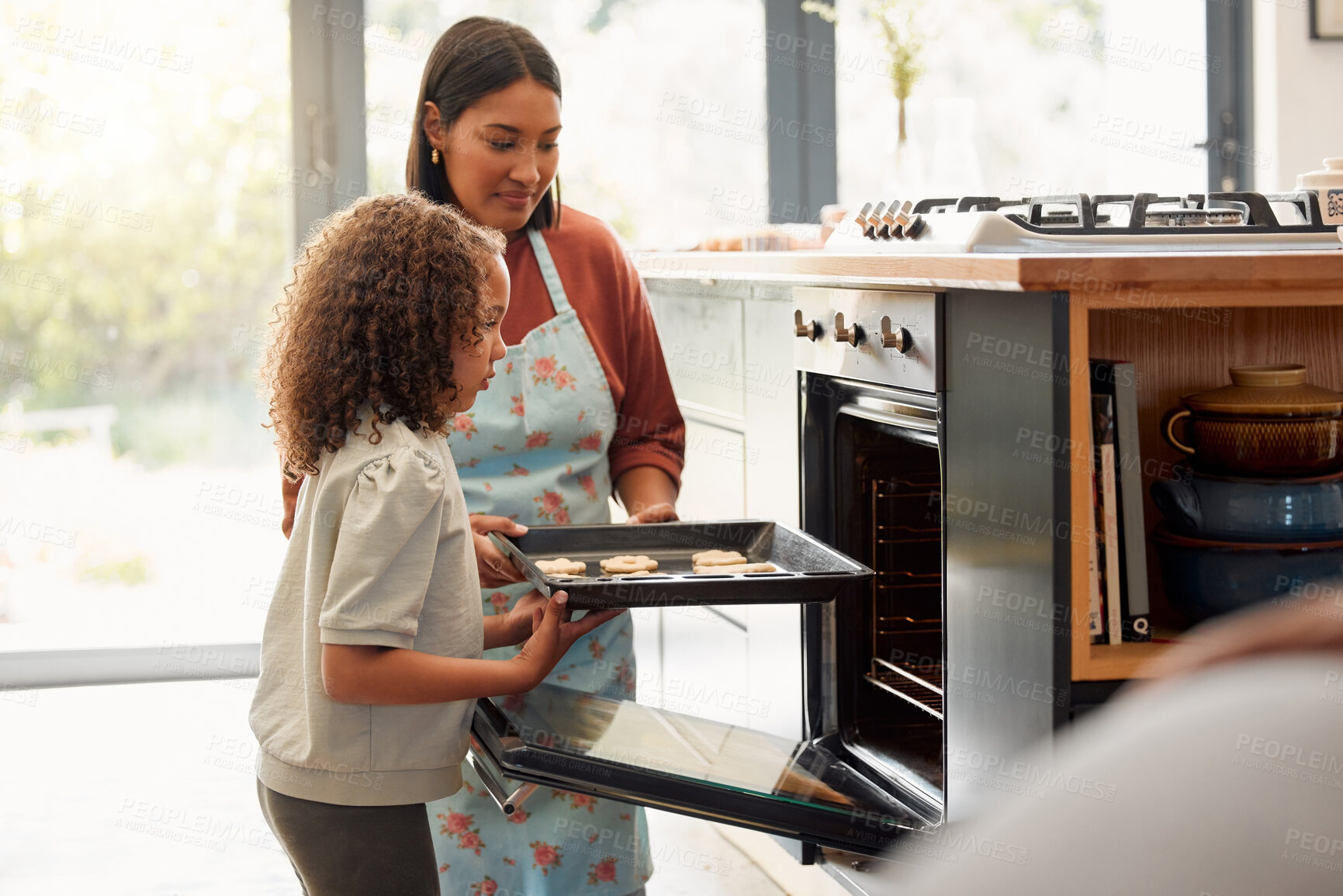 Buy stock photo Mother, kid and baking of cookies by stove for cake recipe, dessert snack or bonding in kitchen. Happy family, woman and girl in home with biscuits in pan or cooking sweet treat with love or learning