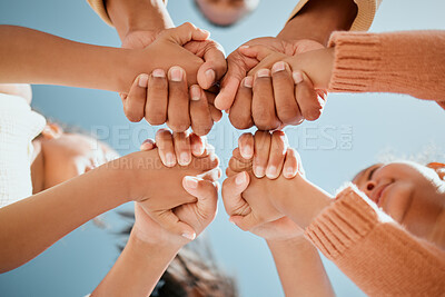 Buy stock photo Children, holding hands and unity below with blue sky for community, care or trust in support. Low angle, closeup or kids with touch, solidarity or union for motivation, youth or friendship in nature