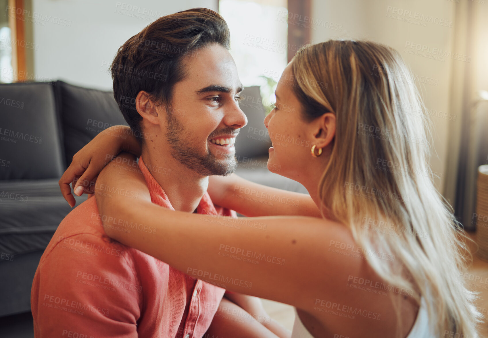 Buy stock photo Love, hug and happy couple relax in home for care, bonding together and communication with partner. Living room, man and woman embrace for romantic relationship, eye contact or connection for loyalty