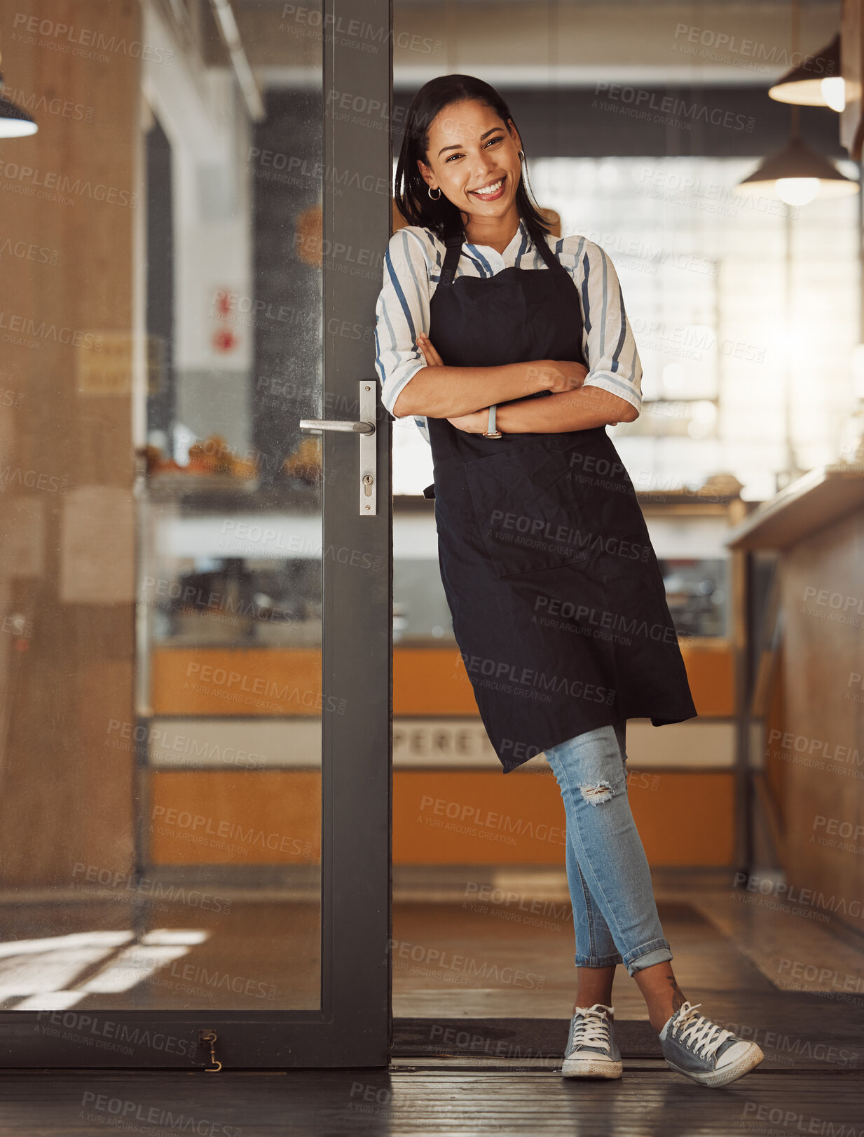 Buy stock photo Portrait, happy woman and coffee shop owner with arms crossed for pride, hospitality and welcome to small business. Smile, cafe and confident entrepreneur, waitress and barista by door in Argentina