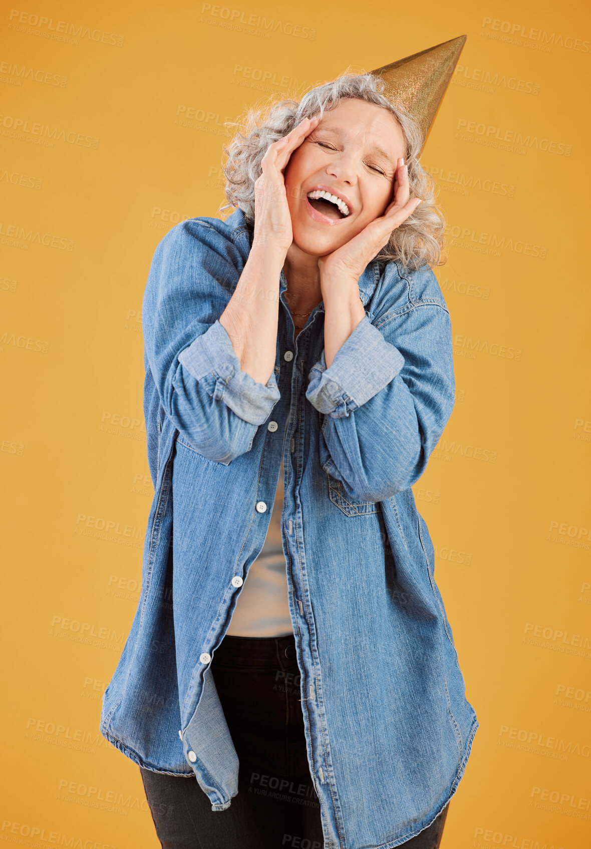 Buy stock photo Birthday, party hat and surprise with mature woman in studio isolated on yellow background for celebration. Milestone, retirement and smile of senior person in casual outfit for carnival or gala