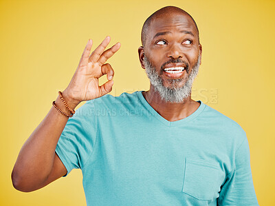 Buy stock photo Black man, approval and okay sign in studio, yes symbol and agreement on yellow background. Mature person, emoji and promotion for feedback in review, opinion and great icon for thank you or support