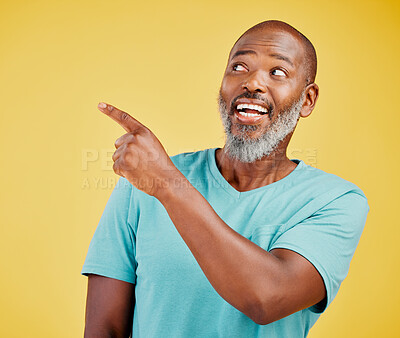 Buy stock photo Black man, excited and pointing in studio for offer, wow and promotion selection. Mature person, happy and gesture on yellow background space for amazing deal, opinion and unbelievable announcement