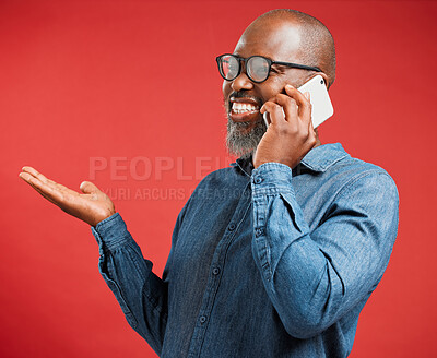 Buy stock photo Mature, black man or talking with phone call in studio for conversation on a red background. African, male person or happy model with smile on mobile smartphone for friendly discussion or chating app