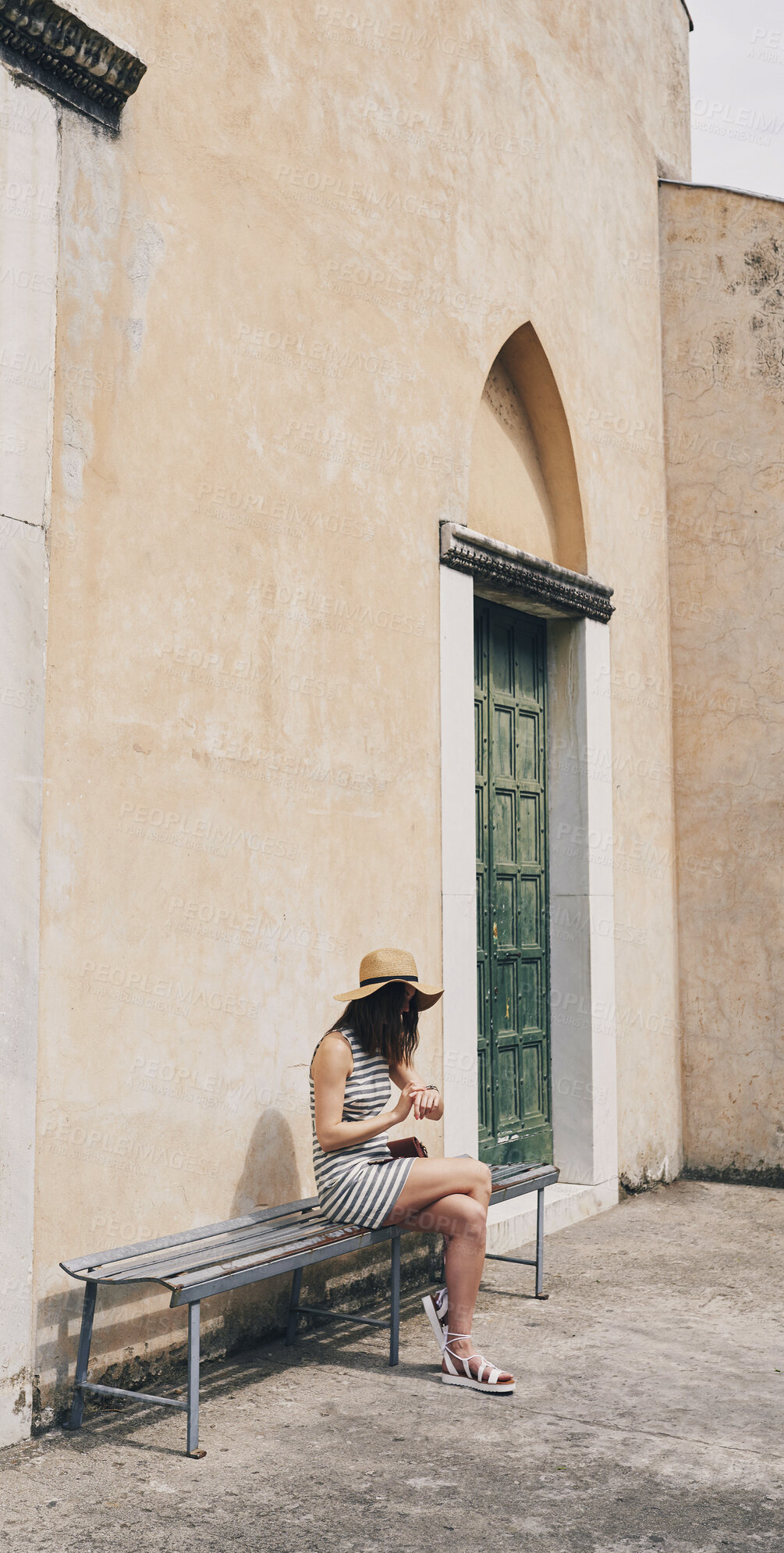 Buy stock photo Woman, check time and vacation in city on bench for transportation, shuttle or bus on sidewalk in spring. Person, watch and outdoor with waiting for taxi by buildings, journey and holiday in Italy