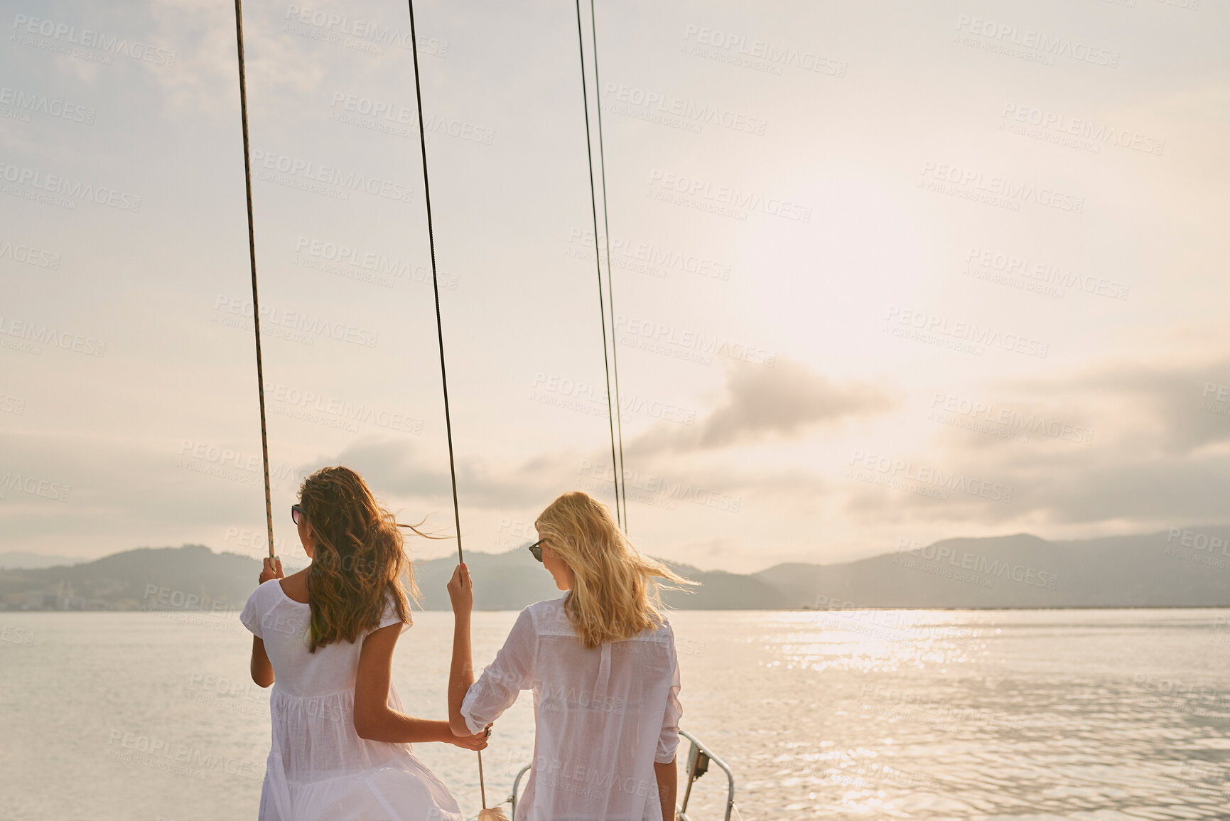 Buy stock photo Friends, women and travel at sunset on yacht with relax, holiday adventure and ocean scenery. Back, girls and sightseeing on vacation cruise in boat for bonding together, tropical island and mockup