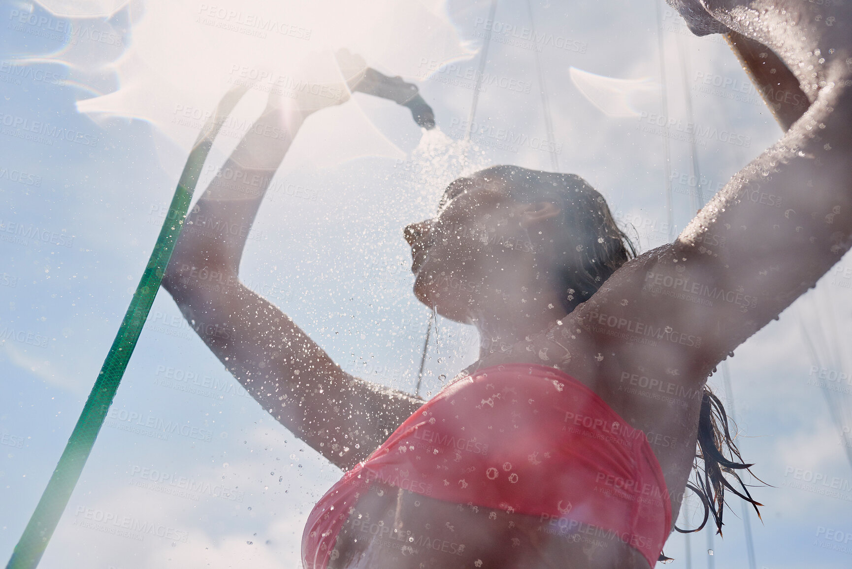 Buy stock photo Travel, woman and hose to shower on boat for cleaning body, hygiene and water splash for swimming. Girl, person and low angle with washing face on holiday cruise for adventure and summer vacation