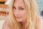 Closeup of the face of a beautiful young caucasian woman on a boat. Face of a beautiful young woman enjoying a vacation cruise