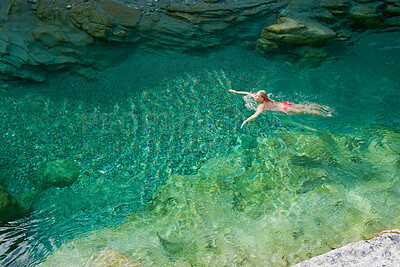 Buy stock photo Above, swimming and travel with woman in lake for adventure, natural springs and summer vacation. Tropical, paradise and environment with person in water of river for exotic, health and relax