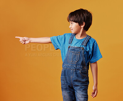 Buy stock photo Kid, pointing and boy with hand gesture, showing and promotion on studio background. Model, mockup space and childhood with discount deal, notification and alert with option, direction or opportunity