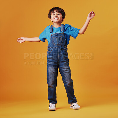 Buy stock photo Japanese kid, boy and happy in studio background for fashion with fun, outfit and swag in Japan. Male person, child and smile or satisfied on portrait in confidence with trendy clothes and style