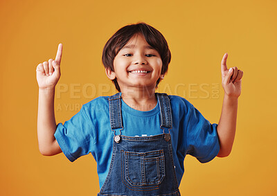 Buy stock photo Japanese kid, boy and pointing in studio background for fashion with fun, outfit and swag in Japan. Male person, child and smile or happy on portrait in confidence with trendy clothes and style