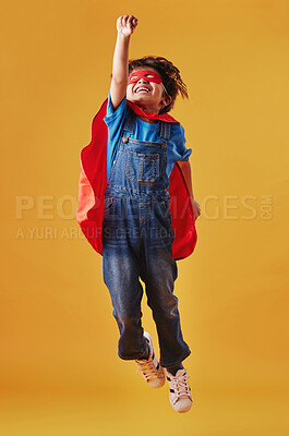 Buy stock photo Boy, flying and superhero costume on studio background, confident and playing fantasy game. Male person, child and character to protect or serve justice, hero courage and proud fighter for power