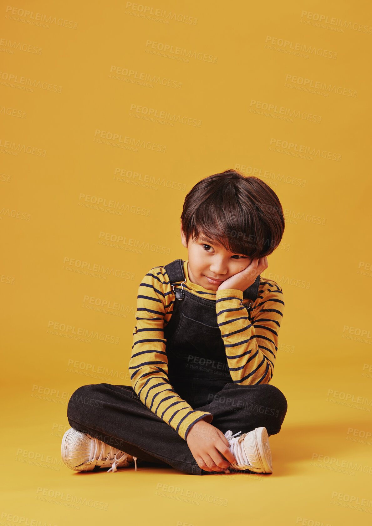 Buy stock photo Bored, lonely and thinking with Asian boy on yellow background, isolated in studio for development. ADHD, depression or sadness and child on floor with mockup space for curiosity or problem solving