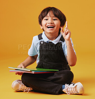 Buy stock photo Books, education and child in studio with idea for studying with test, assignment or development. Scholarship, student and Asian kid with learning elementary school for future by yellow background.