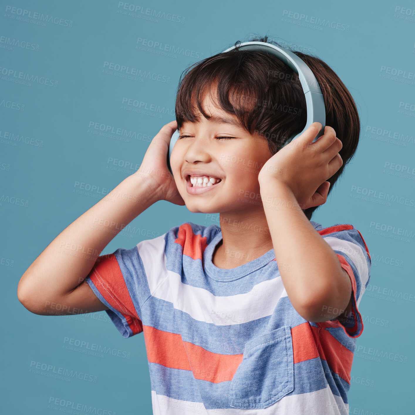 Buy stock photo Japanese boy, kid and happy with headphones in studio background for streaming music and playlist. Male person, child and smile or enjoy with eyes closed with fun, entertainment and online album