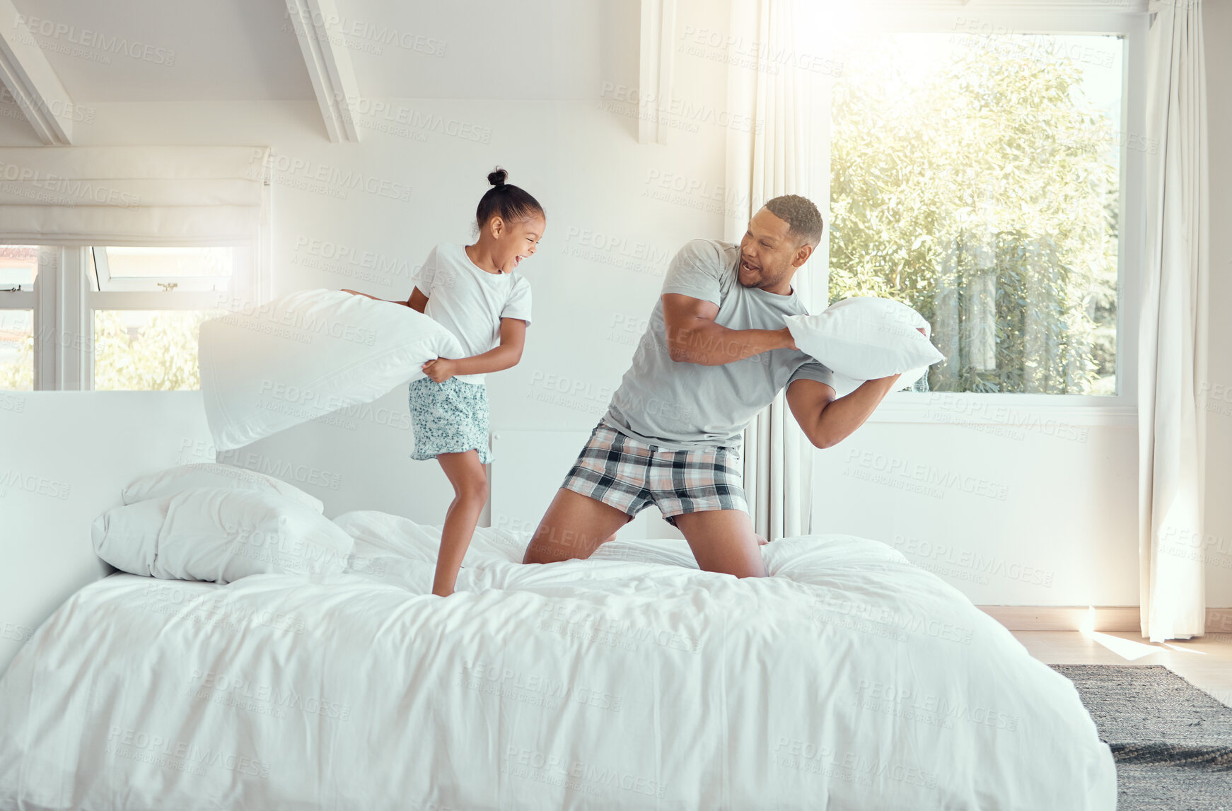 Buy stock photo Family, bedroom and pillow fight in house, happiness and game or bonding with girl. Love, fun and father together in apartment with energy, smiling and weekend break in playful home for relationship